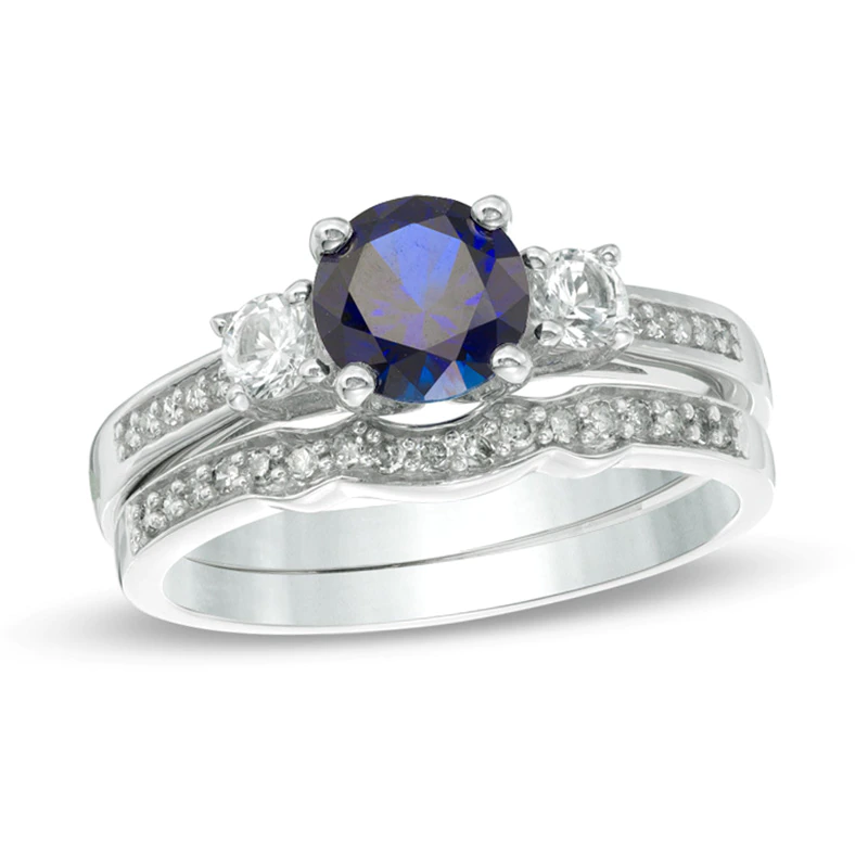 6.0mm Blue and White Sapphire with 1/8 CT. T.W. Diamond Three Stone Bridal Set in 10K White Gold