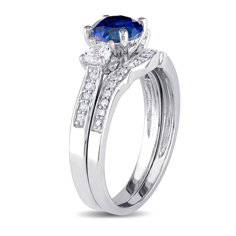 6.0mm Blue and White Sapphire with 1/8 CT. T.W. Diamond Three Stone Bridal Set in 10K White Gold